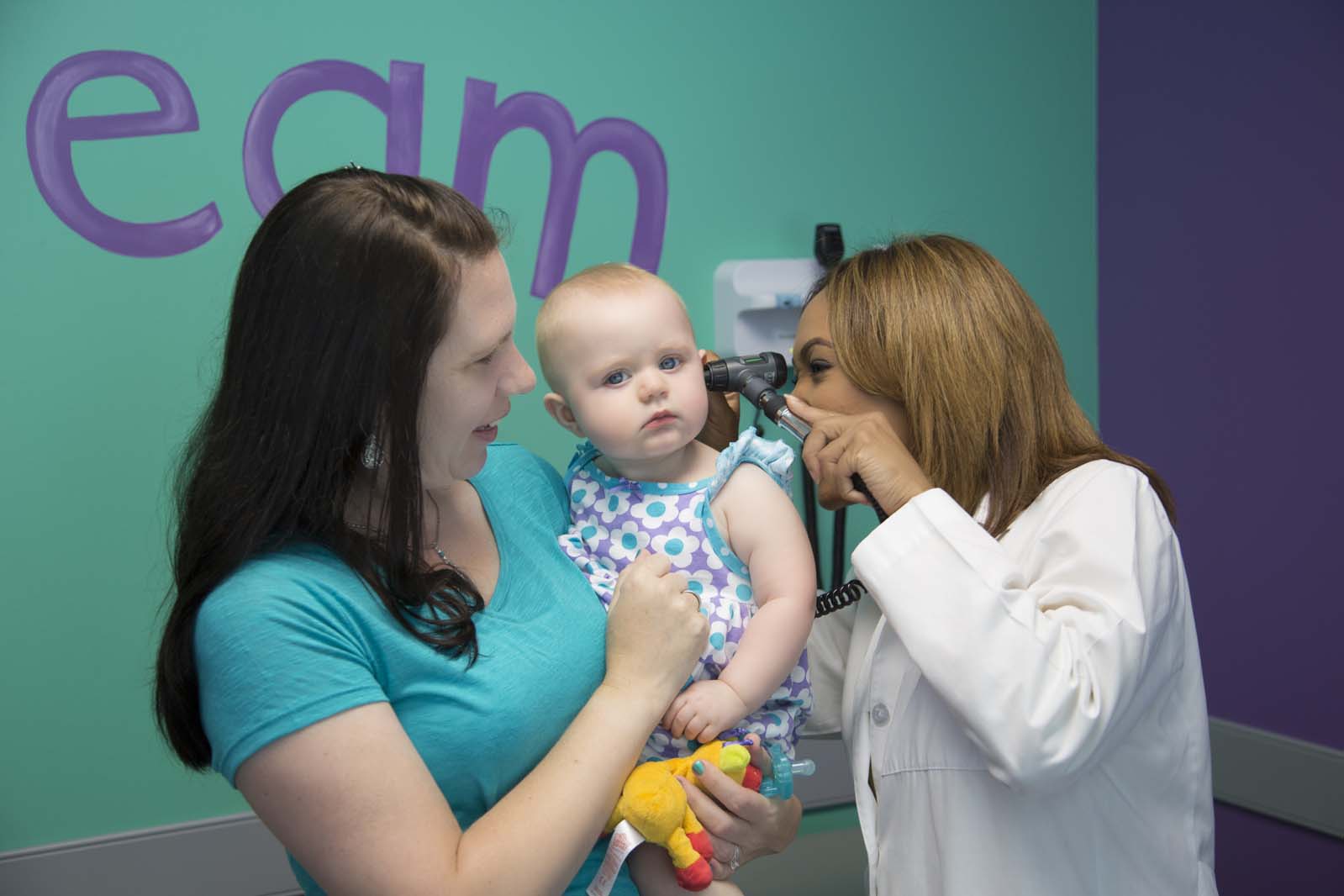 A Premier Pediatric Associates doctor caring for a baby